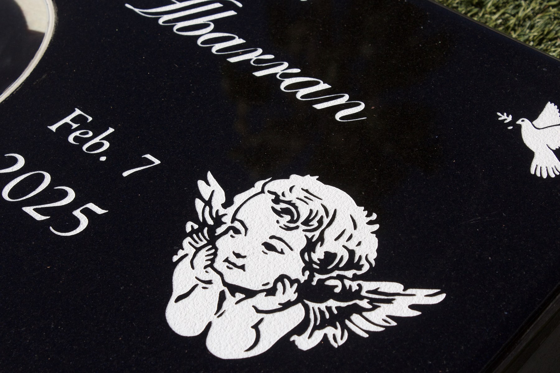 Detailed memorial engraving artwork on polished black granite by GVG Memorials